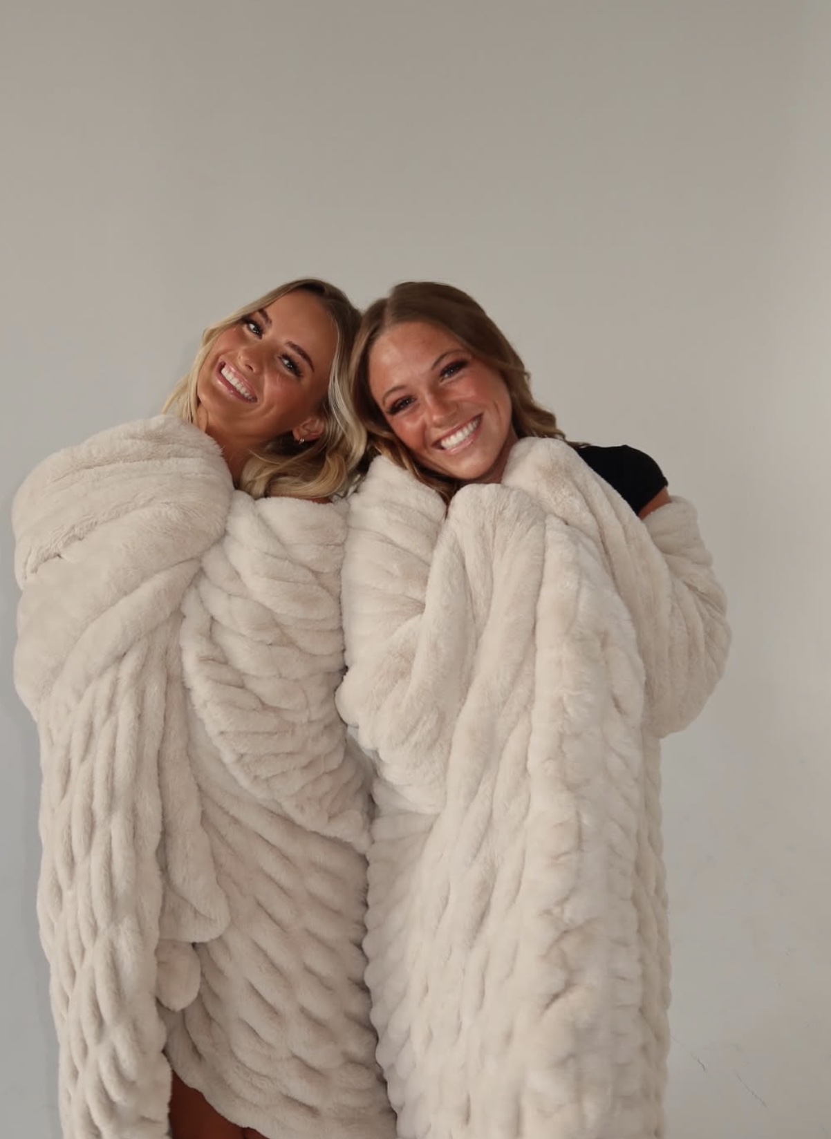Two Weber State dancers wrapped in cream Birdie blankets